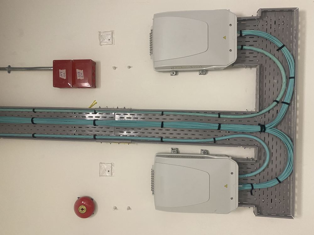 Structured fiber riser cabling to wall-mounted enclosures