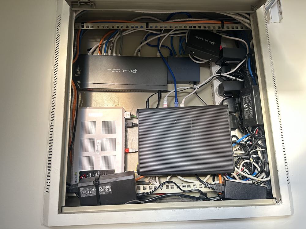 Wall-mounted network cabinet with switches and PoE devices